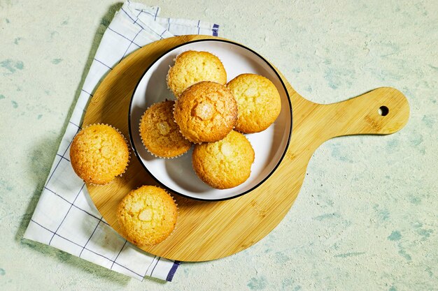 Vanilla Caramel Nuts Muffins In Paper Cups on cutting board