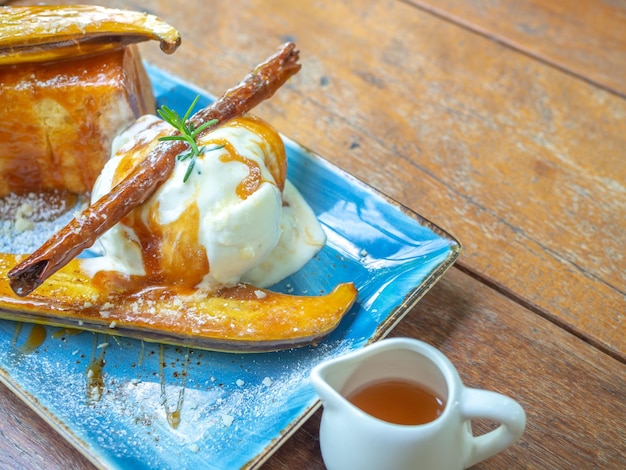 Vanilla Ice cream topping with caramel on ceramic plate Closeup Caramelized Banana Toast homemade dessert