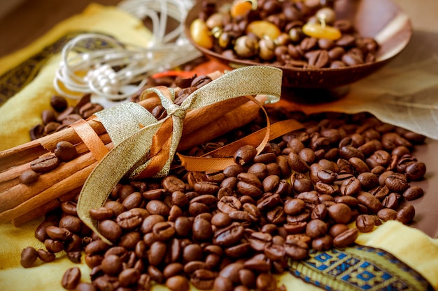 Vanilla pods, cinnamon and brown coffee beans background.