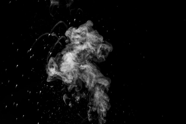 Vapor steam rising over black background Splashes and drops of water Curly white steam rising up and splashing water