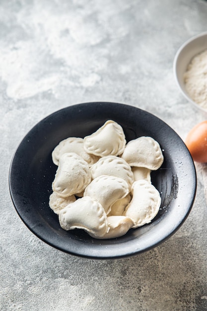 vareniki raw stuffed dumplings ready to cook meal snack on the table copy space food background