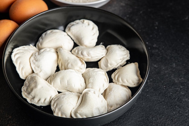 vareniki raw stuffed dumplings ready to cook meal snack on the table copy space food background