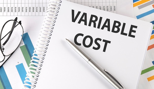 Photo variable cost pen and glasses on the chart business concept