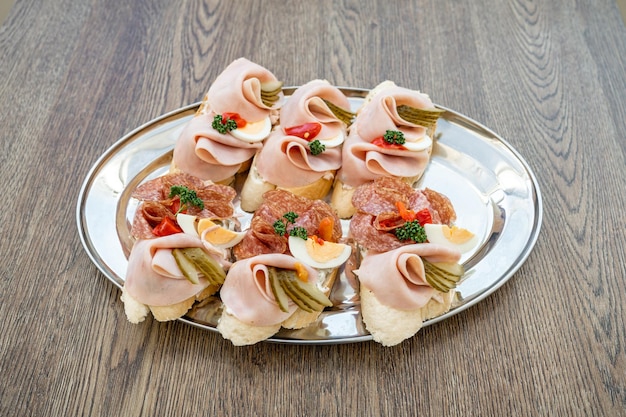 Variation of bread with spread of cheese ham egg and vegetables