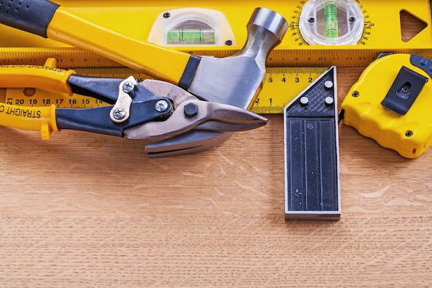 Variation of construction tools on wooden background maintenance concept