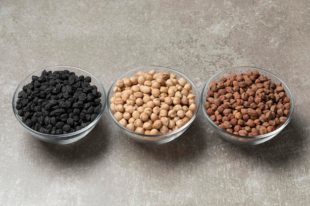 Variation of different chickpeas in a bowl on a stone background