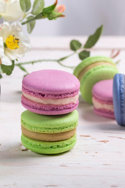 A variety of almond French macaroon biscuits on a light wooden table