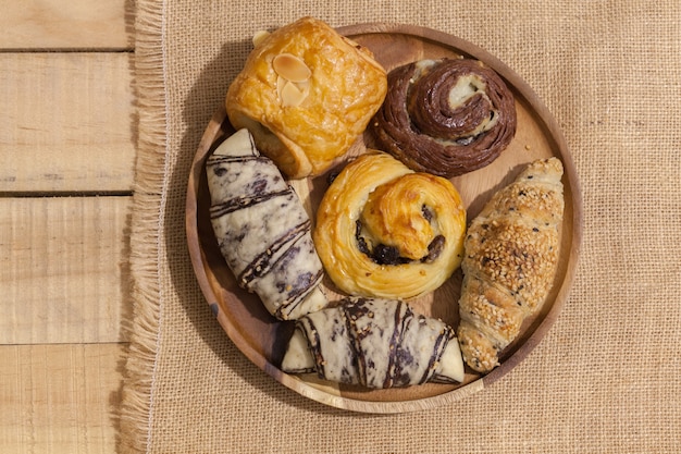 a variety of bakery on wooden plate