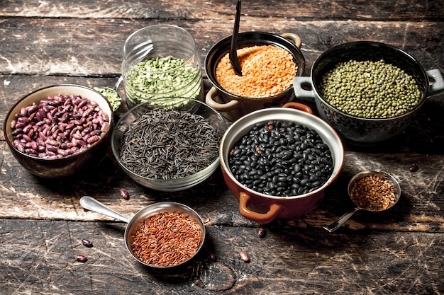 Variety of bean seeds in a bowl on a wooden table