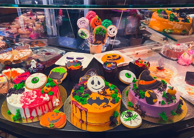 Variety of cakes decorated in style of Halloween in the pastry shop window