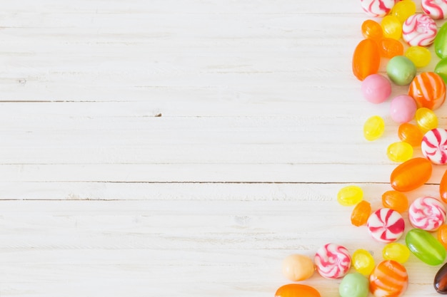 Variety of candies on a wooden table