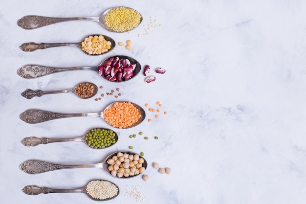 A variety of cereals and legumes on vintage boats and a light