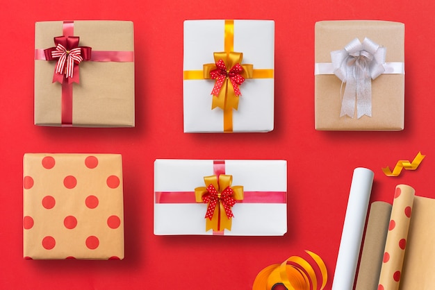 Variety of christmas gifts isolated on red table