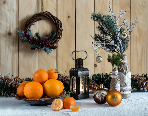 A variety of Christmas tree ornaments oranges and tangerines on the table closeup