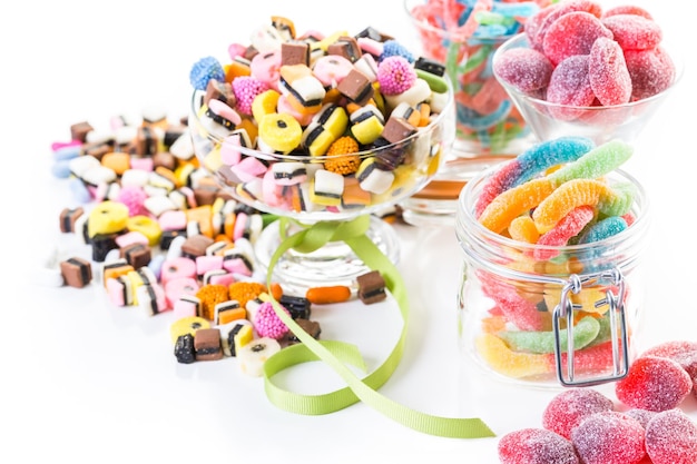 Variety of colorful candies on a white background.