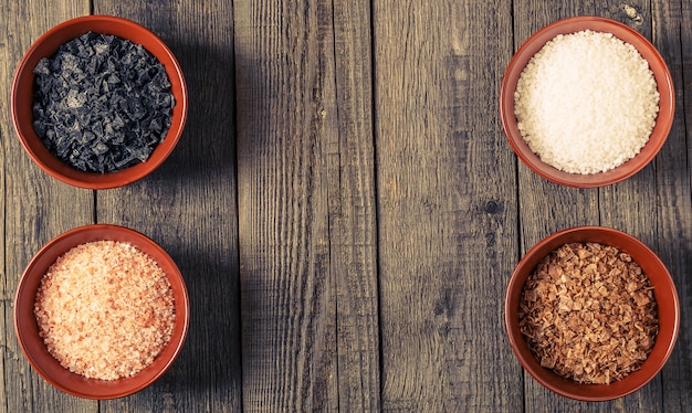 Variety of Different Sea Salts in ceramic bowls.