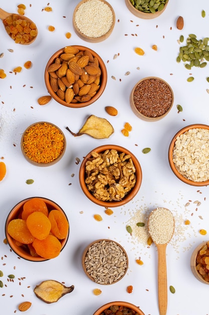 A variety of foods including nuts, seeds, and seeds are on a white background.