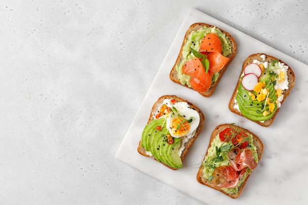 Variety of Healthy sandwiches set of toasts with avocado Slice of whole grain bread with avocado