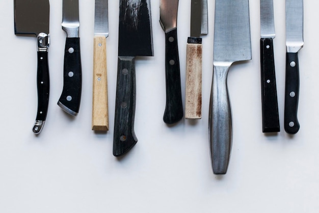 A variety of knives on a plain background Knife crime concept