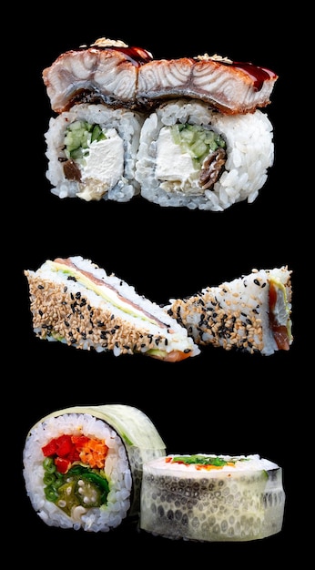 A variety of maki sushi on a glossy black background