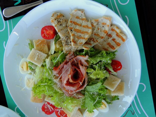 Variety Meat Served With Lettuce On A White Plate