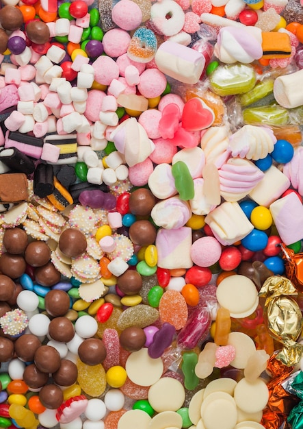 Variety of milk chocolate and jelly sugar gum sweets and candies to use as background Macro