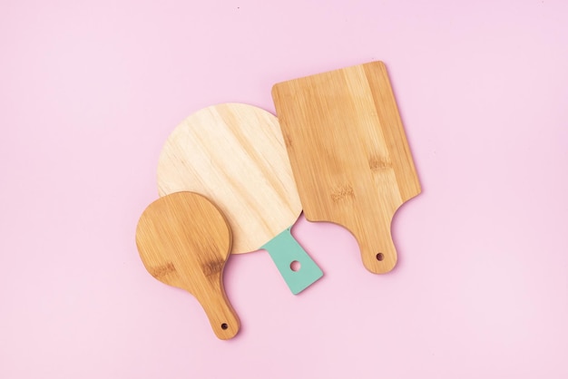 Variety of Multifunctional Circular Wooden Cutting Board for Cutting or Serve Pink Background Top View