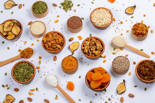 A variety of nuts and seeds are on a table.