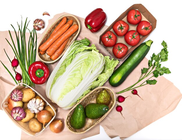 A variety of organically grown vegetables are stacked diagonally on rough paper or in packaging Healthy food concept organic food kitchen ingredients