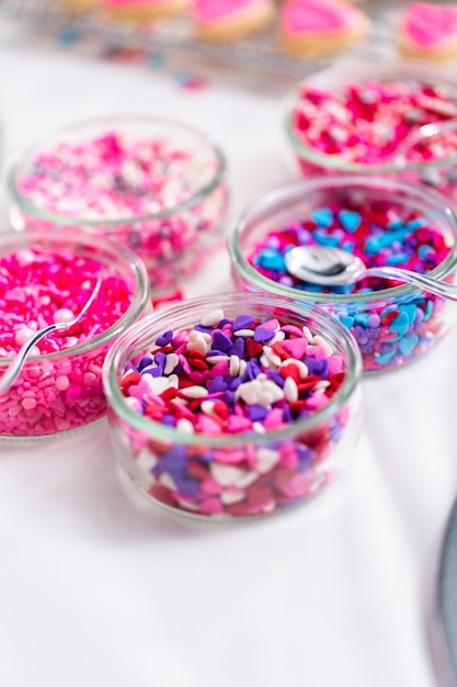 Variety of pink sprinkles for decorating Valentine's day cookies.