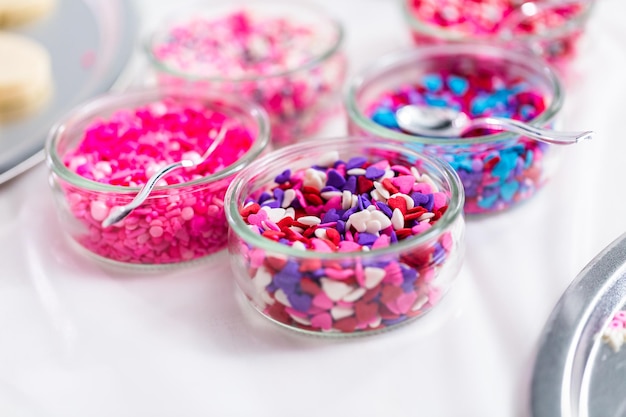 Variety of pink sprinkles for decorating Valentine's day cookies.