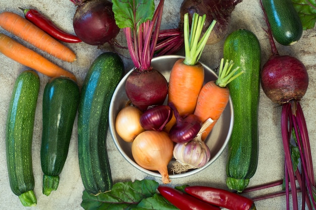 Variety of raw vegetables on wooden table. 