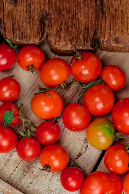 Variety ripe natural organic delicious tomatoes Group of fresh tomatoes on wooden background