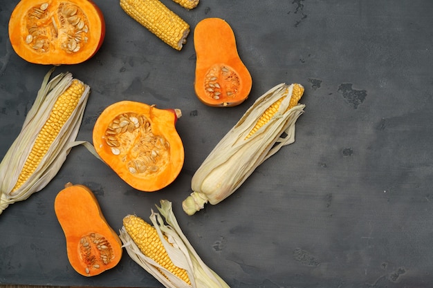 Variety of ripe vegetables including pumpkin and corn