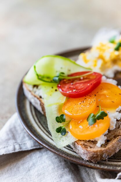 A variety of sandwiches with multigrain bread cream cheese vegetables and eggs