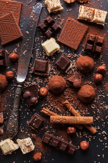 Variety of sweet homemade chocolate pralines on wooden background