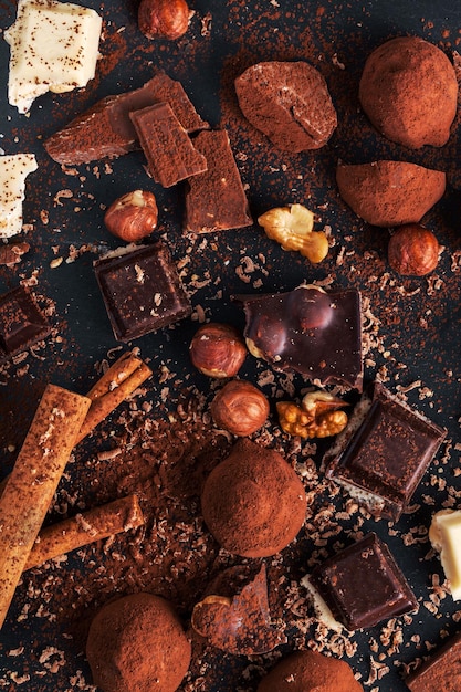 Variety of sweet homemade chocolate pralines on wooden background