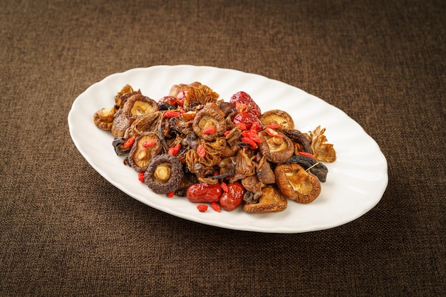 Variety of washed mountain products placed in a white porcelain dish on a monochrome background