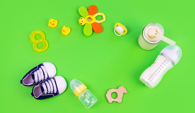 Various accessories for babies. green background. selective focus.