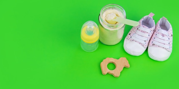 Various accessories for babies. green background. selective focus.