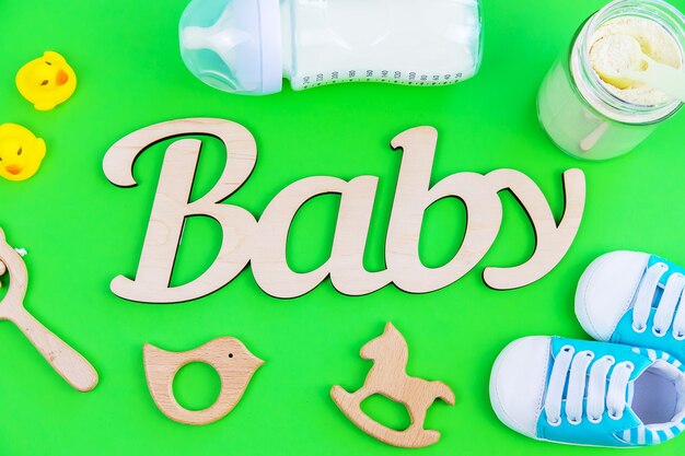 Various accessories for babies. green surface. selective focus.