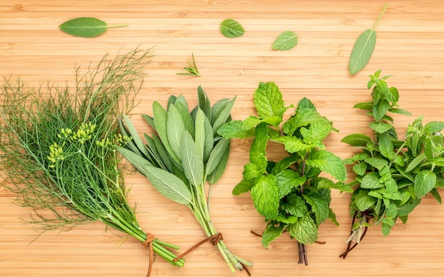 Various aromatic herbs and spices  set up on wooden background .