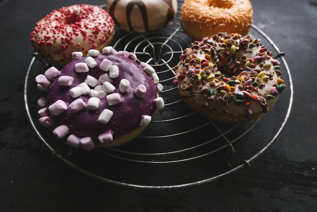 various baked donuts on a bakery grid, sweet food