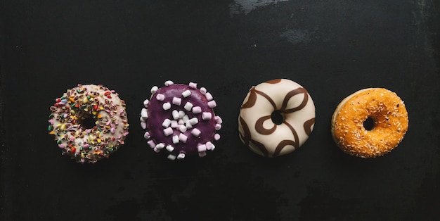 various baked donuts in a row, sweet food