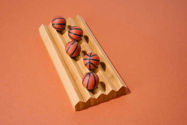 Various basketballs on a wood and red background. sport and competition.copy space. 3d illustration