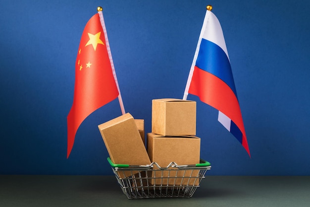 Various boxes in a food basket and two flags on a blue background