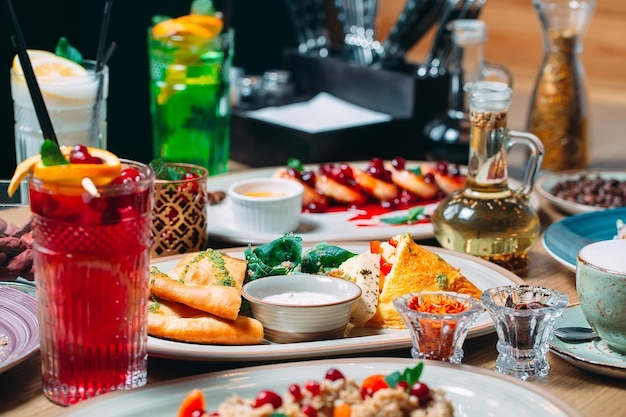 Various breakfast dishes are served on the table in the restaurant.