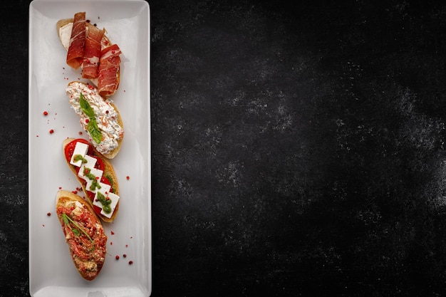 Various Bruschettas with ham seafood vegetables and cheese