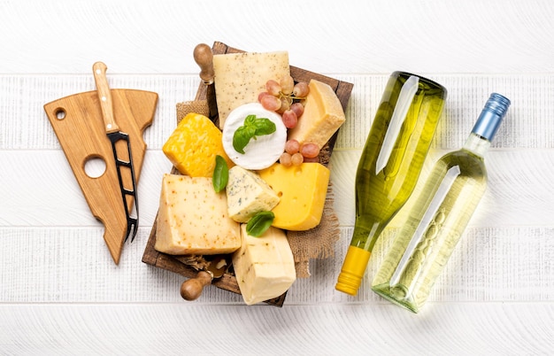 Various cheese on board and white wine