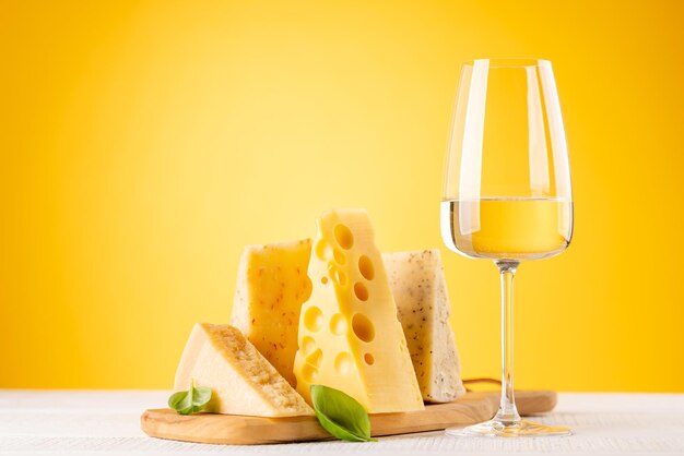 Various cheese on board and white wine